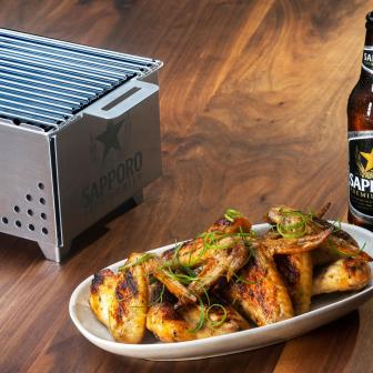 Sapporo beer served with grilled chicken wings with white sauce