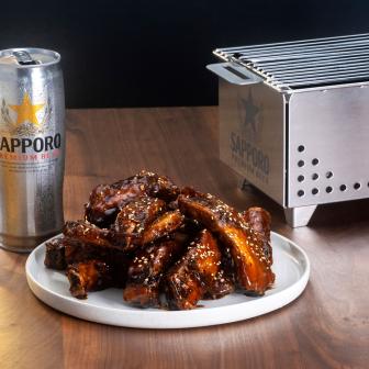 Sapporo beer served with ribs marinated in tare glaze